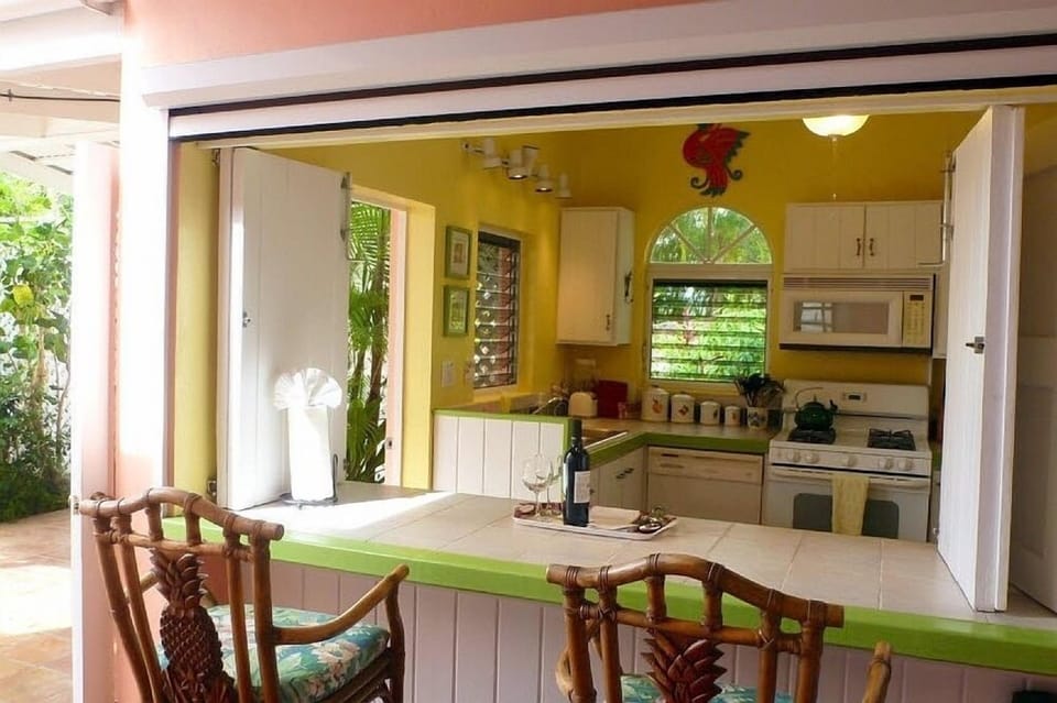 The well equipped main kitchen; the breakfast bar includes a motorized screen