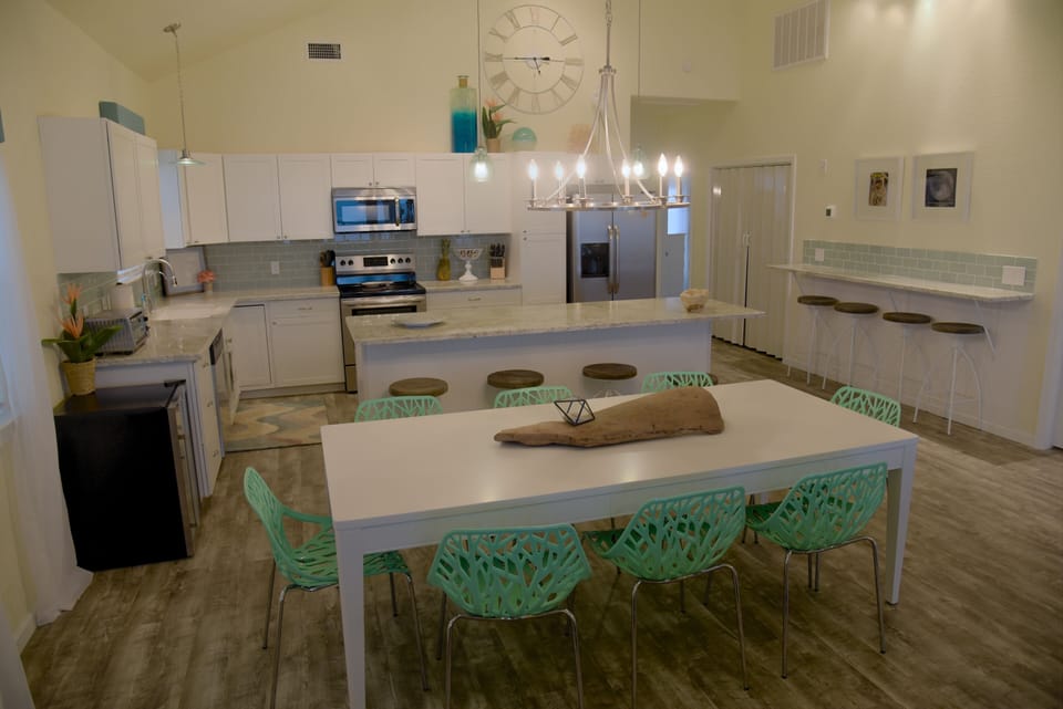 Seating for 16, plus high chair & toddler table. Includes beverage fridge.