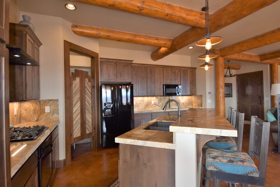 Gourmet custom kitchen with 5 top gas burning stove.