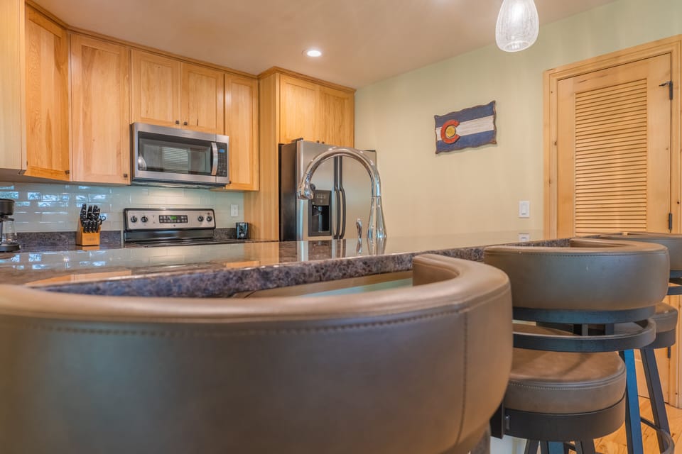 Bar stool seating looking into kitchen area