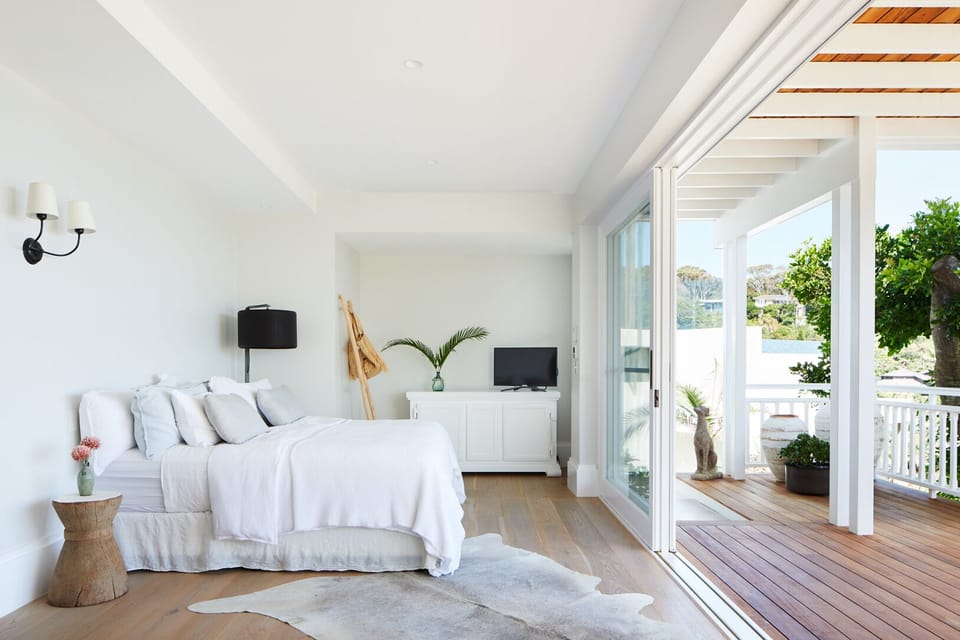 Bed is facing huge 8 meter sliding windows capturing the views of wategos.