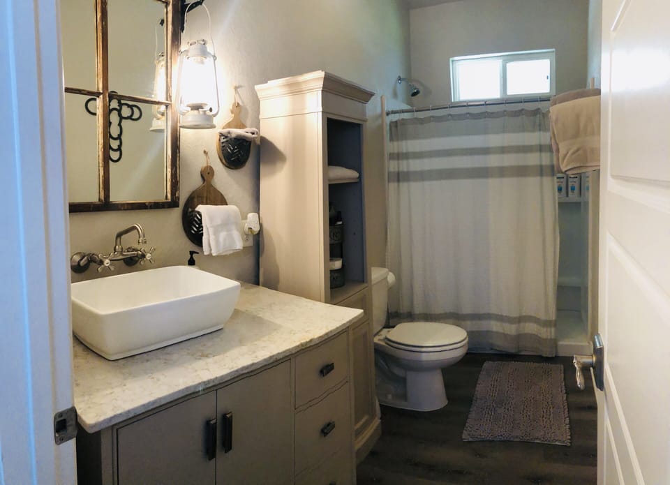 The bathroom is stocked with extra towels and soaps.