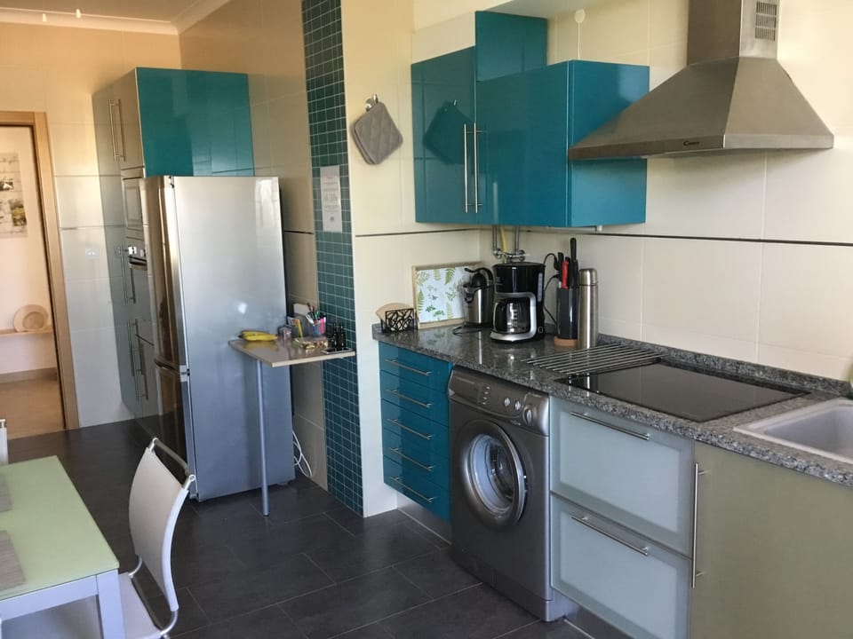 Kitchen with a table for four, entrance from the hall.