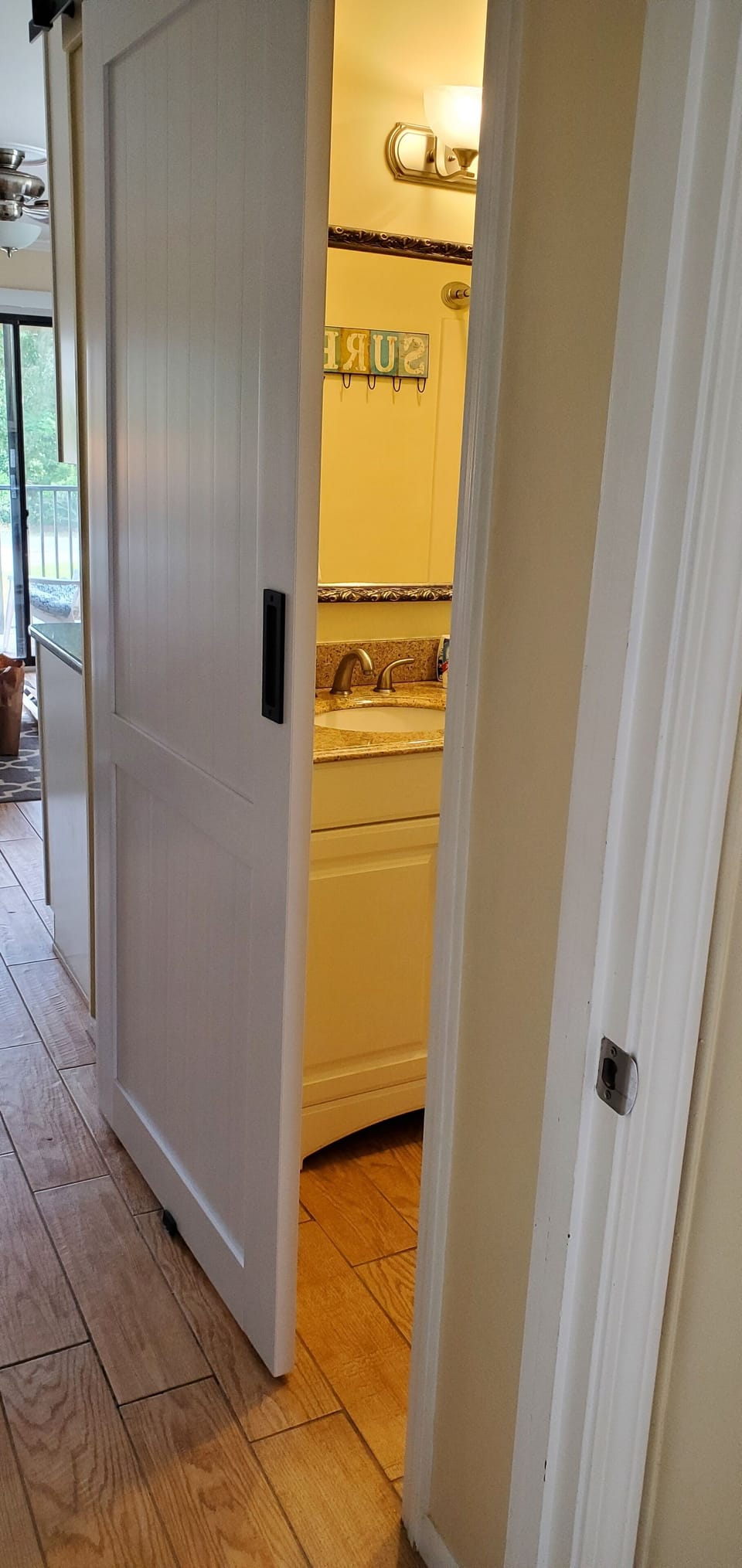 New barn door installed to maximize bathroom space.