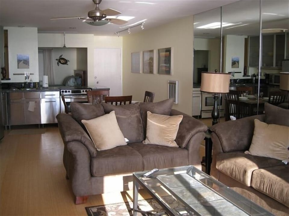 Open floor plan with second bedroom in background.