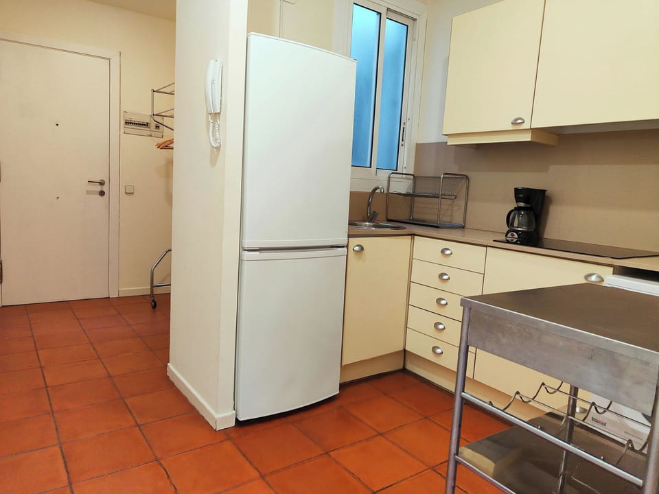 Entrance leads directly to a fully equipped kitchen area.
