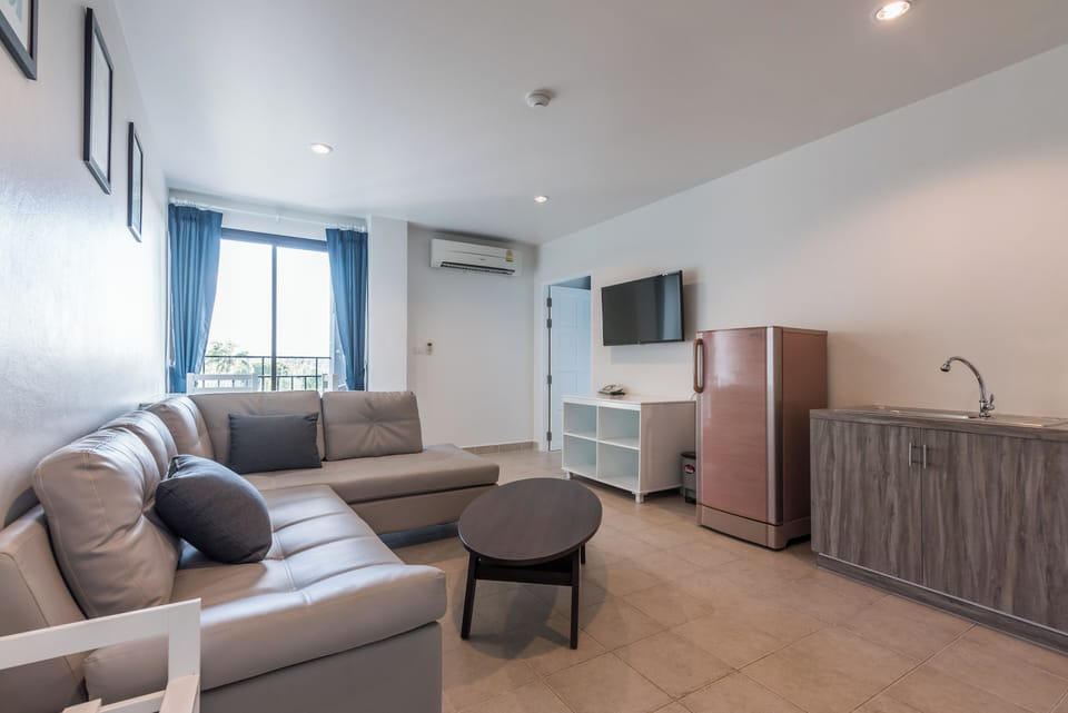 Suite, 1 King Bed, Garden View (Suite One Bedroom Garden View) | Living area | 42-inch Smart TV with cable channels, TV