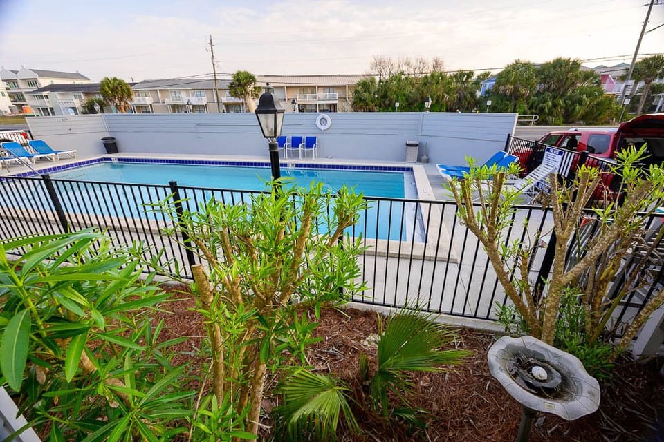 Pool is on the front of complex NOT beachside tall wood  privacy fence 