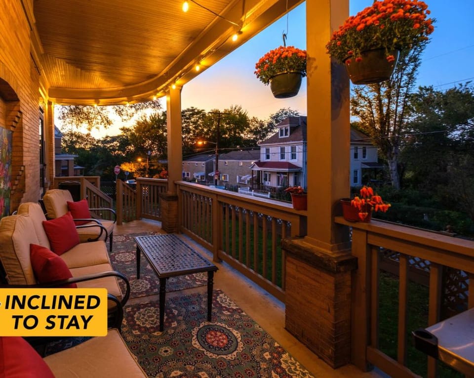 Warm Evenings, Glowing Porch – The wraparound porch sets the mood with string lights, cozy seating, and historic charm that invites you to linger a little longer.