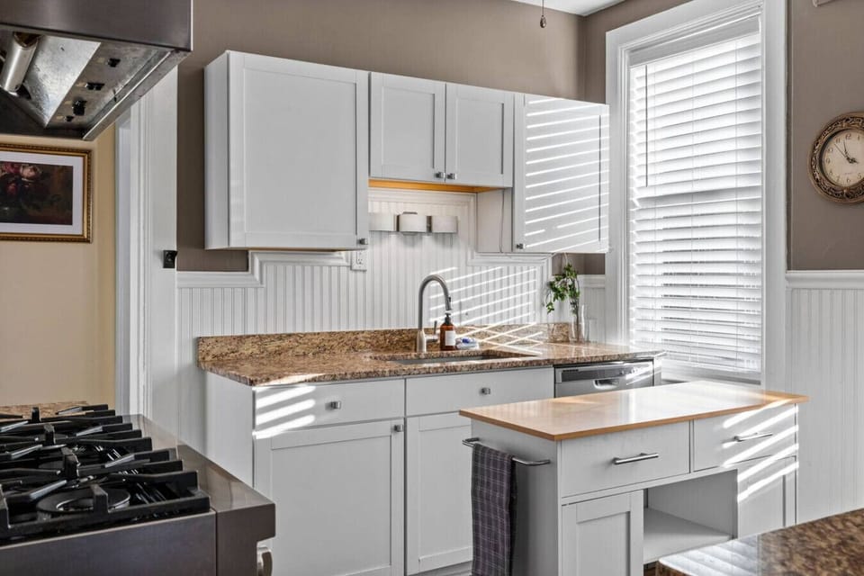 Bright Mornings Begin Here – A sun-drenched corner of the kitchen welcomes you each day with warmth, filtered light, and modern charm.