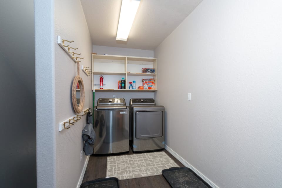 The laundry room features a full sized washer and dryer