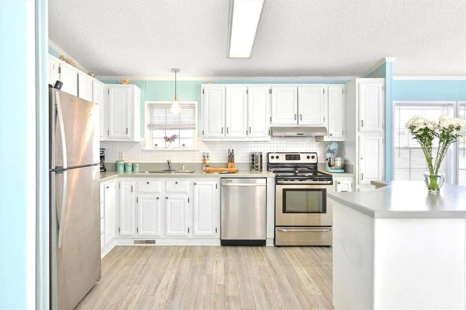 Large open concept kitchen with stainless steal appliances, lots of counter space and great views of the bay as you cook your meals at home!  