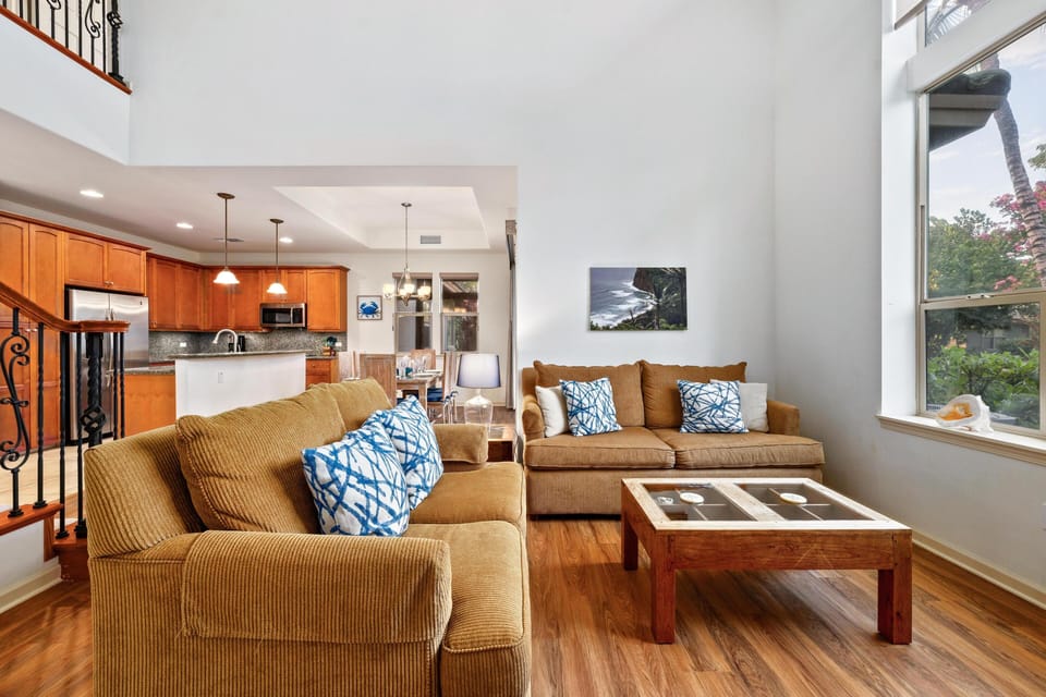 Spacious living room with vaulted ceilings and large windows