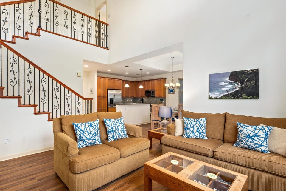 Spacious living room with vaulted ceilings and large windows