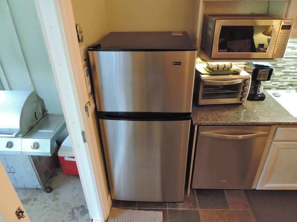 Enjoy indoor and outdoor living by stepping out to covered lanai with private BBQ