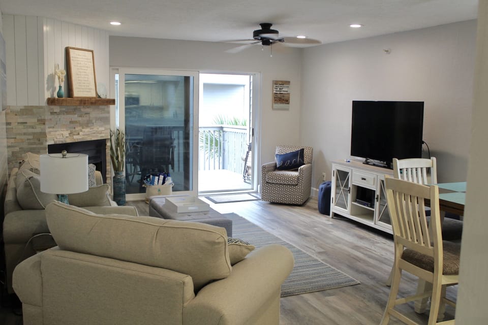 Open floor plan with lots of seating space, 50" TV, kitchen, and half bath