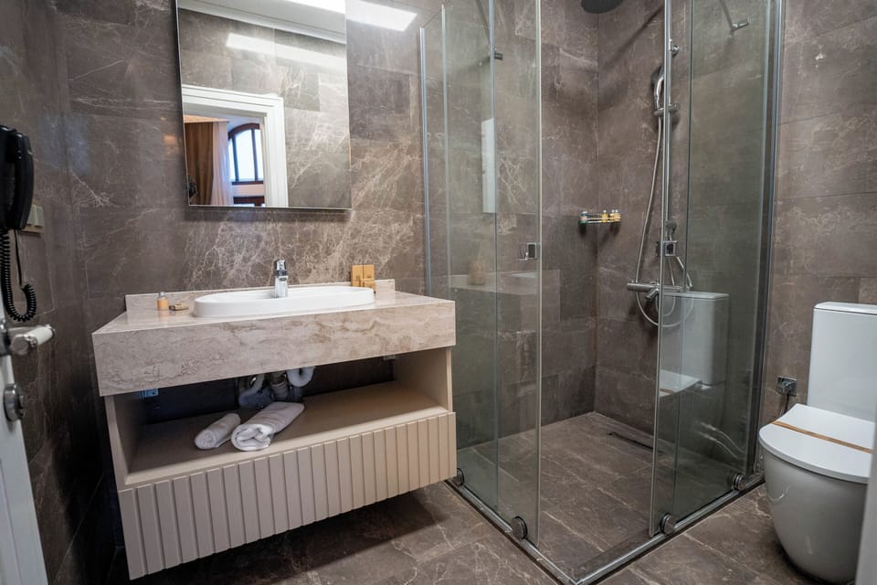Shower, hair dryer, slippers, towels