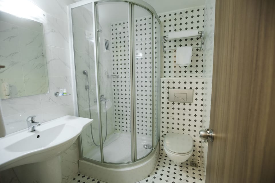 Shower, hair dryer, slippers, towels