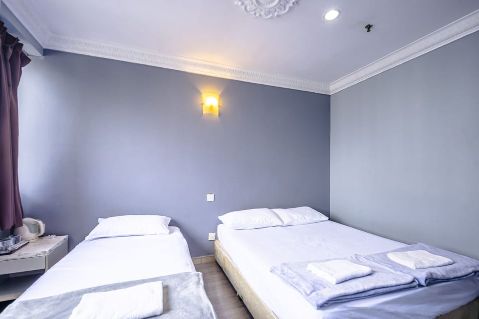 Triple Room | Desk, blackout drapes, WiFi (free), bed sheets
