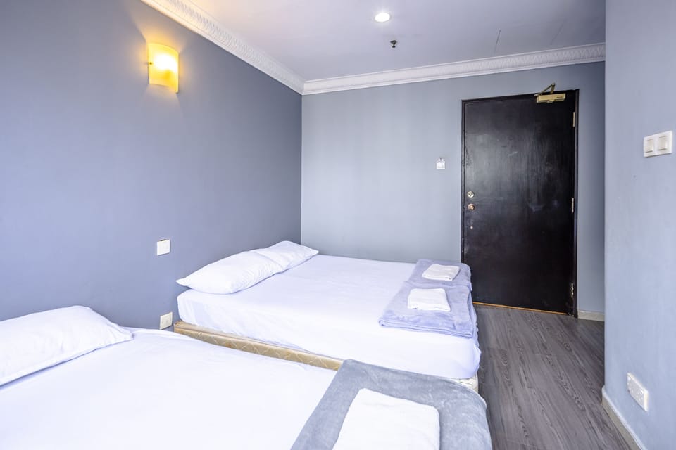 Triple Room | Desk, blackout drapes, WiFi (free), bed sheets