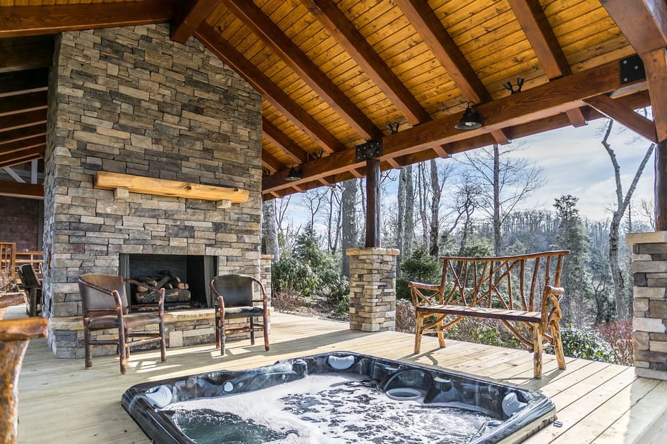 Covered deck with fireplace and hot tub