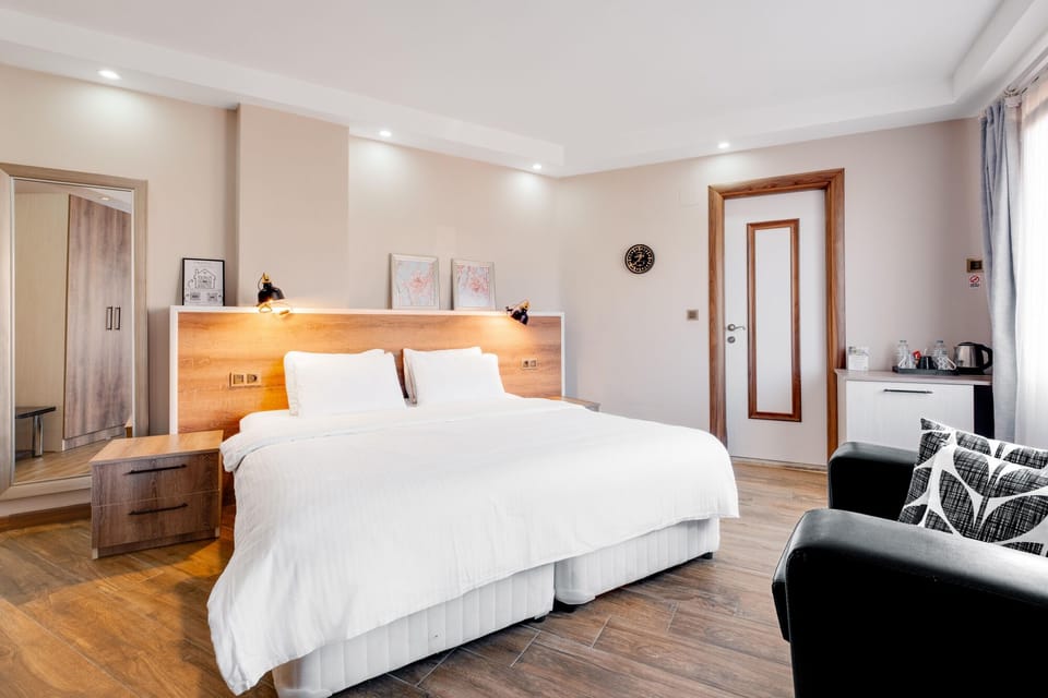 Standard Quadruple Room, Multiple Beds, Non Smoking | Minibar, desk, laptop workspace, iron/ironing board