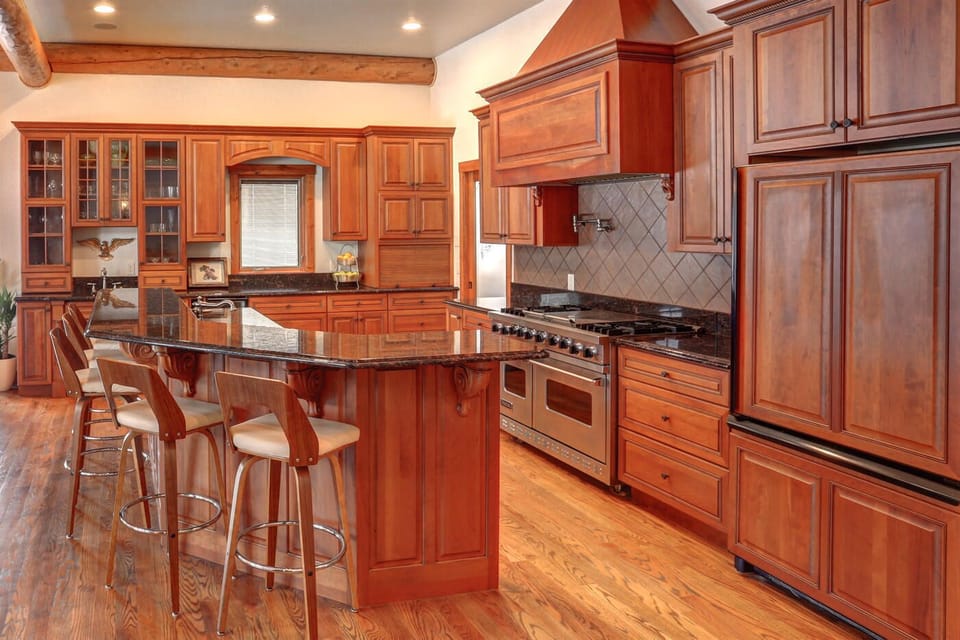 Island sits eight.  Wood cabinets are beautiful grained cherry.