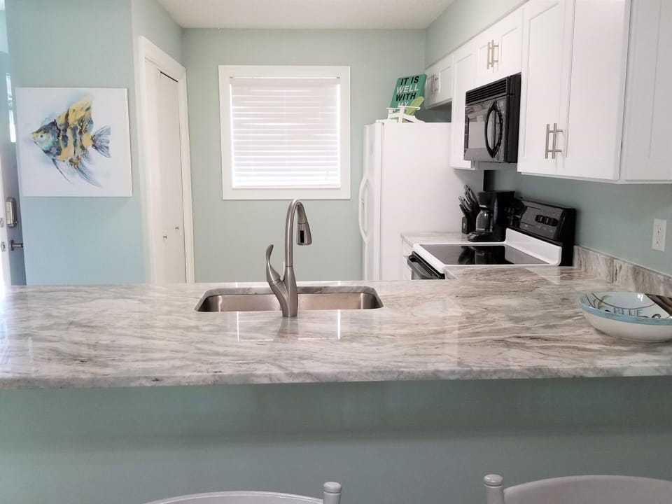 Beautiful kitchen with brand new cabinets, countertop, deep sink & Delta faucet!
