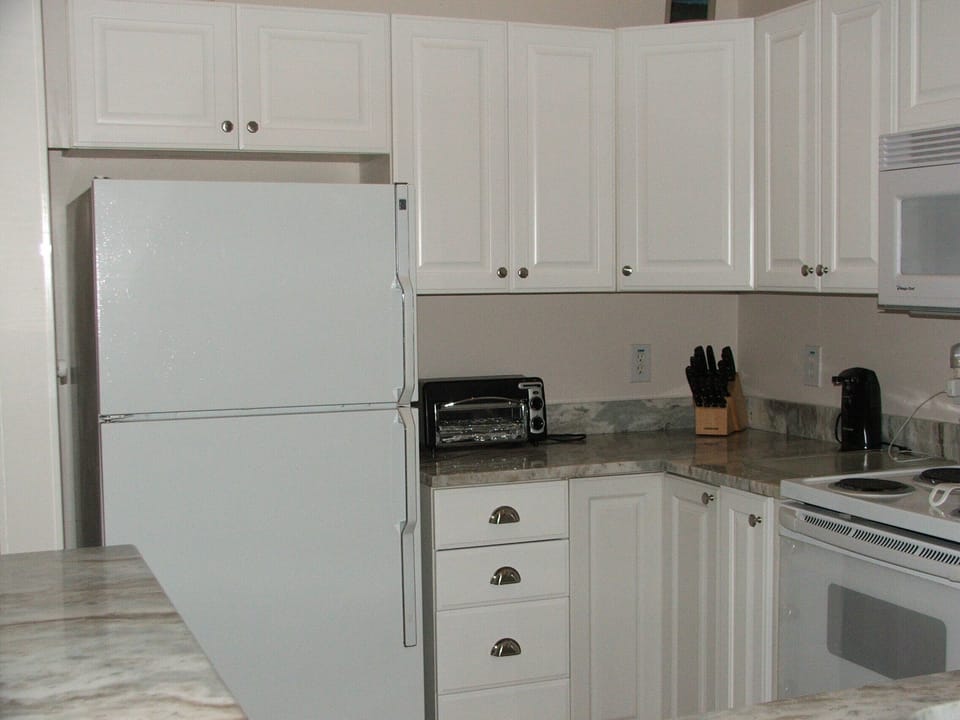 Granite Counter tops in  well-stocked kitchen.