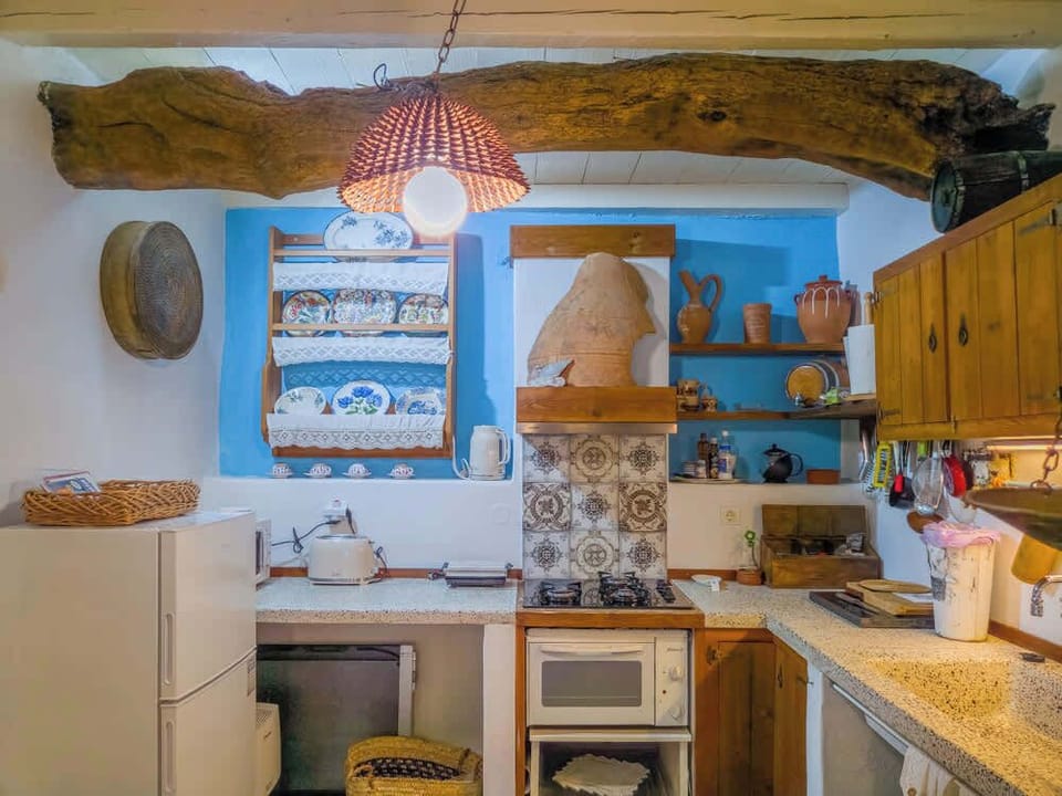 Kitchen with wooden sealing beams and ample working space