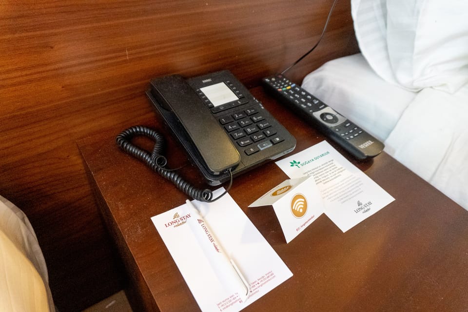 Deluxe Triple Room | Minibar, in-room safe, desk, laptop workspace