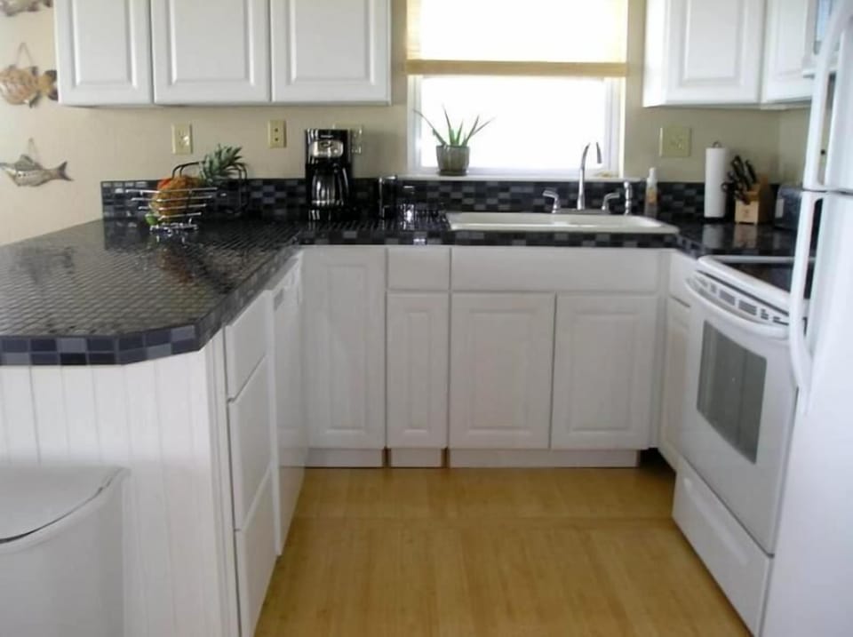 Kitchen with glass tile countertop.