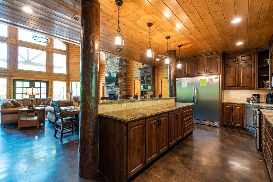 The large dining table and kitchen bar provide seating for the entire group.