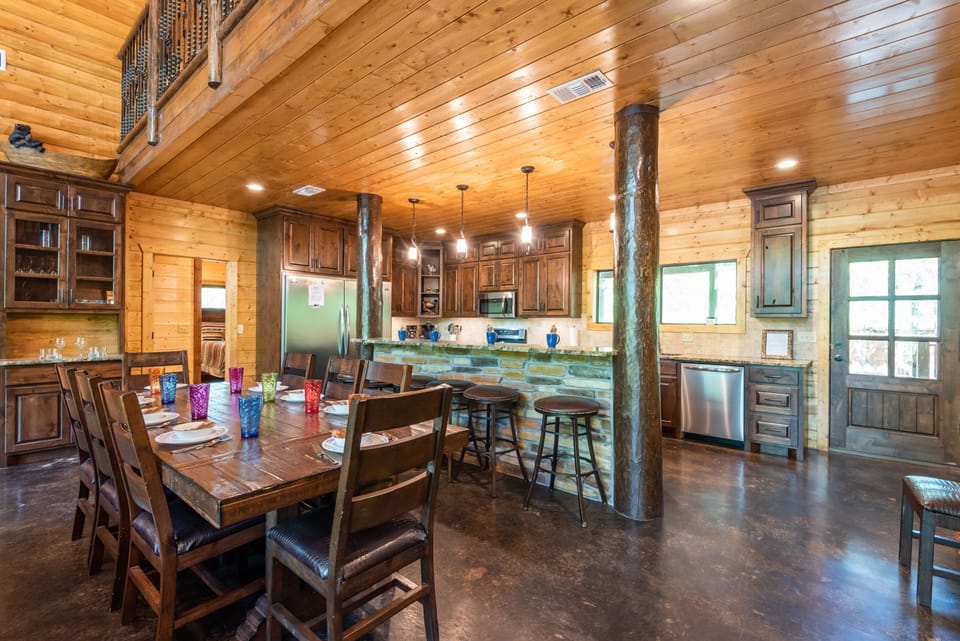 The fully stocked chef’s kitchen features a gas double oven and oversized refrigerator.