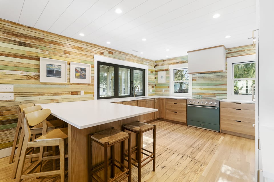 The centerpiece of the remodeled, fully furnished kitchen is a green induction oven. It has a peninsula that seats five, a beverage station, and a walk-in pantry.