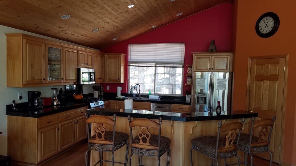 Beautiful kitchen with breakfast bar.  Well stocked pantry.