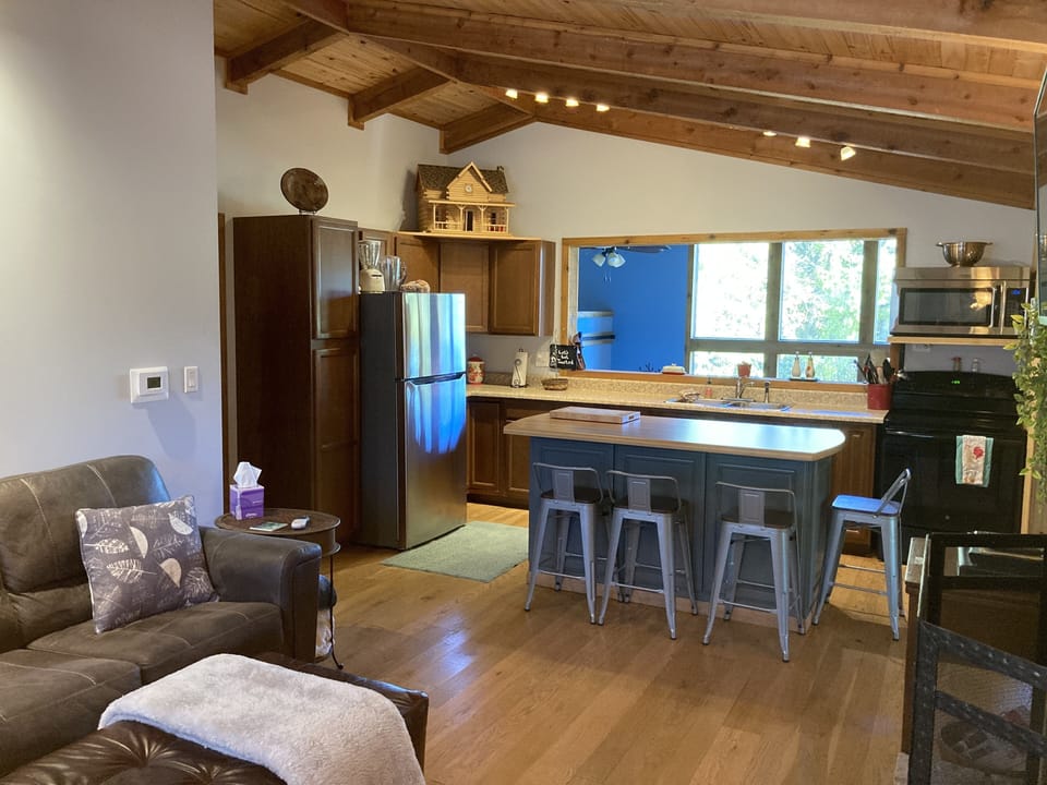 Living room open concept to kitchen and sunroom.