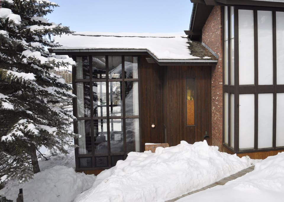 Exterior in winter. Our end unit features beautiful two-story glass windows!