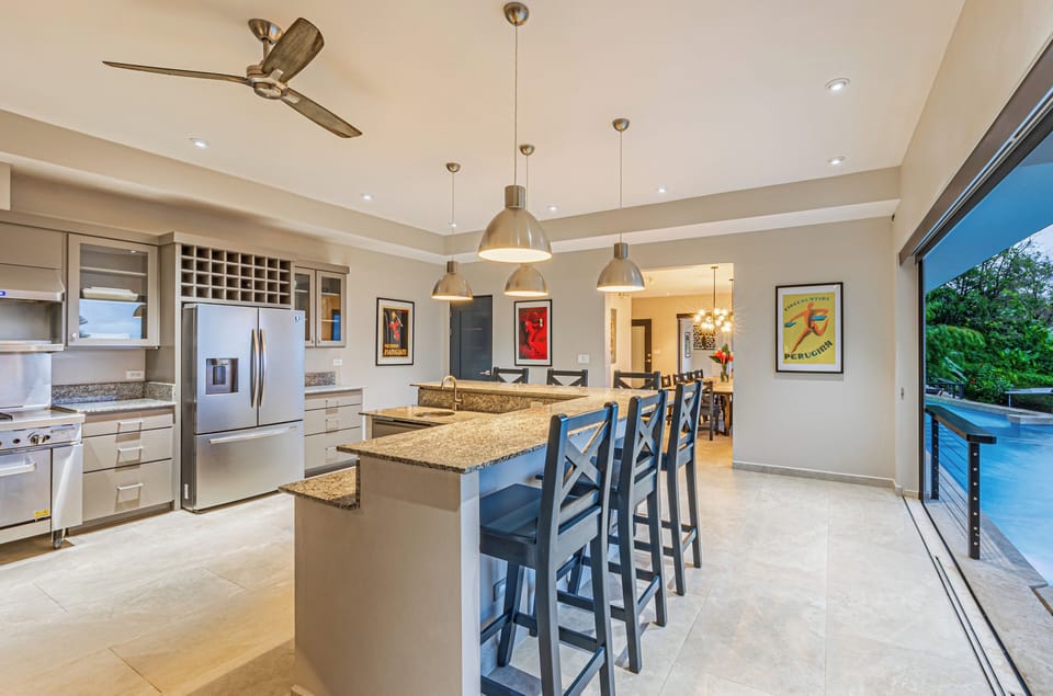 Pool front spacious "all stainless" kitchen with Bar seating and A/C
