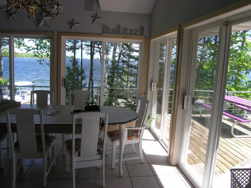 Dining room at morning sunrise with view to lake.