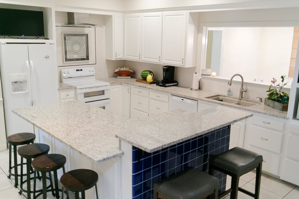 Large kitchen, new granite countertops, all appliances, TV and bar seating.