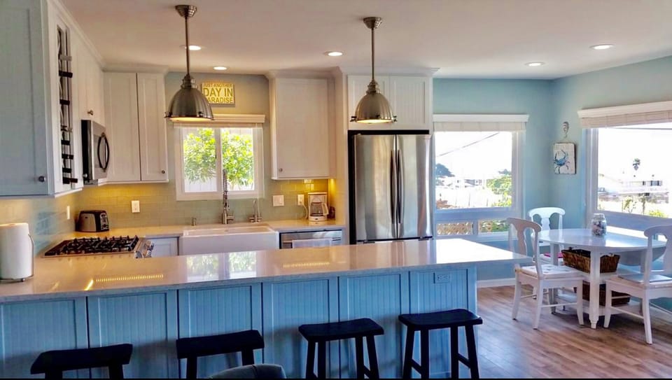 Gourmet kitchen with ample work space on quartz counters. Seating for 8