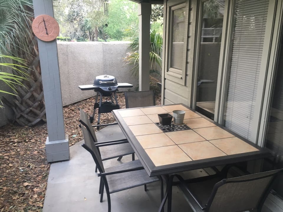 Large dining table and electric Charbroil grill for outdoor dining enjoyment.