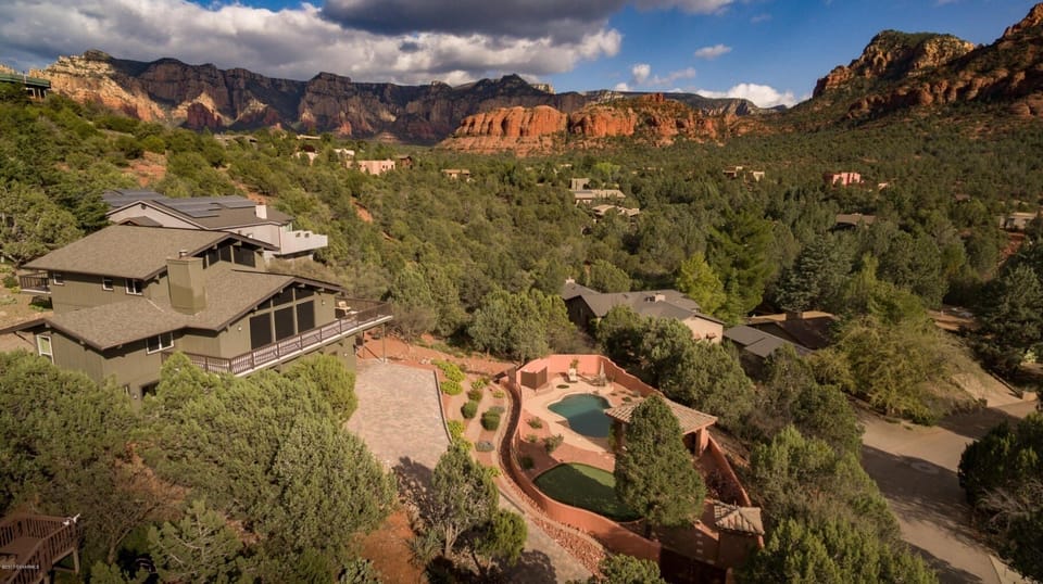 Huge lot with 2 driveways, swimming pool, spa, and stunning red rock views.