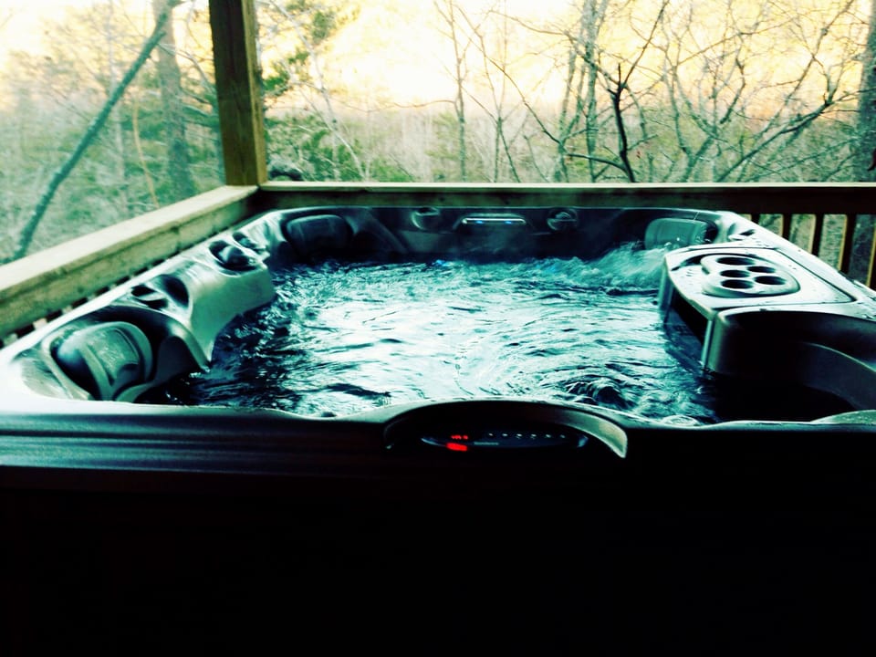 Hottub on screened in porch, overlooks river