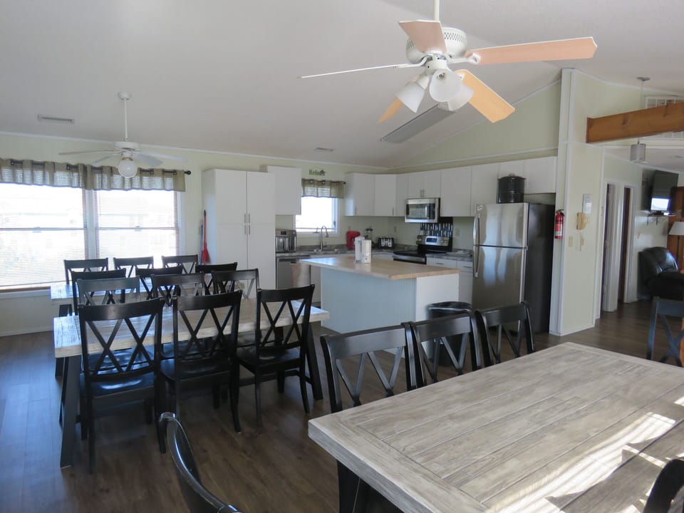 Top floor has an open floor plan  with kitchen, dining area, and living area