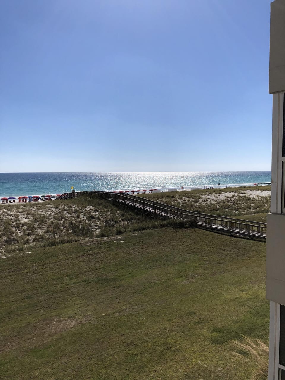 The walkway leads you from the pool area right to the white sandy beach.