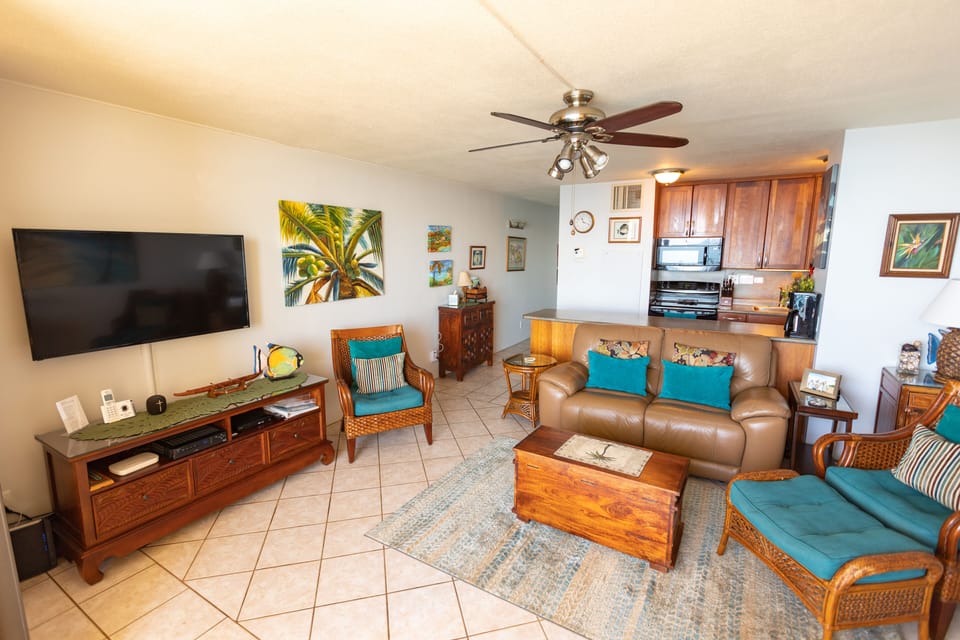 comfortable seating with leather sofa, two side chairs, living room ceiling fan