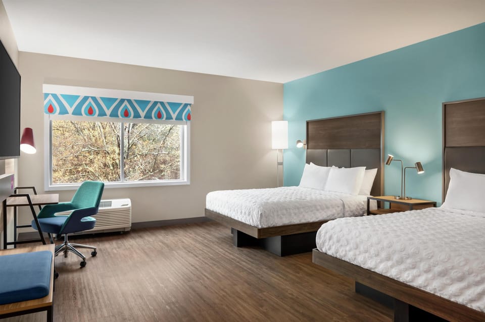 Premium bedding, desk, laptop workspace, blackout drapes