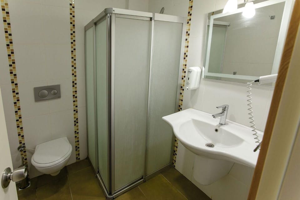 Standard Room | Bathroom | Free toiletries, hair dryer, slippers, towels